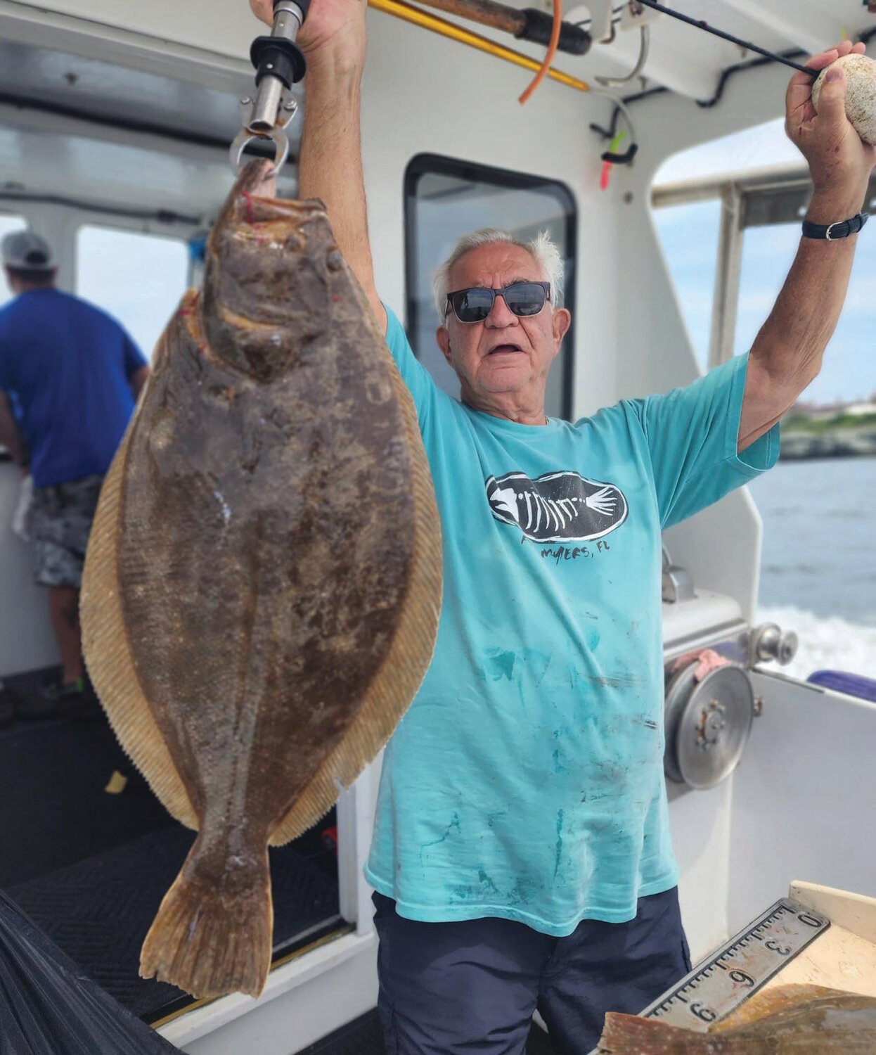 FLUKEZILLA: Duke Pasyanos Sr. of Portsmouth with the 12 pound summer flounder he caught off Newport on ArchAngel Charters last week. (Submitted photo)